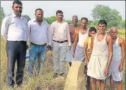  ?? HT PHOTO ?? Villagers with a boundary stone in Lucknow district.