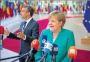  ?? BLOOMBERG ?? ▪ German Chancellor Angela Merkel (right) and French President Emmanuel Macron speak to the media upon their arrival at the EU leaders summit in Brussels on Thursday.