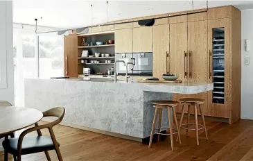  ?? ?? Natalie Du Bois won the 2021 NKBA Supreme Kitchen Design Runner-Up Award for this Midcentury-styled kitchen with beadblaste­d woodgrain cabinetry.