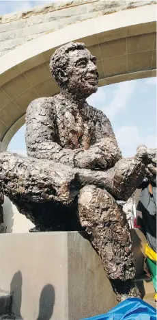  ?? KEITH SRAKOCIC/THE ASSOCIATED PRESS FILES ?? A statue of Fred Rogers by renowned sculptor Robert Berks at a waterfront memorial in Pittsburgh depicts the children’s television pioneer changing his shoes as he always did in the beginning of his show.