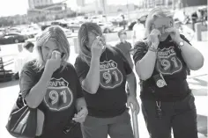  ?? John Locher/Associated Press ?? ■ From left, Linda Hazelwood, Michelle Hamel and Jann Blake, all from California, cry Monday as they attend a prayer service on the anniversar­y of the Oct. 1, 2017, mass shooting in Las Vegas. The three saw bullets hit the ground near them when they attended the country music festival last year, and they housed other attendees in their hotel room that night. “We needed this closure,” Blake said. “It’s been a heavy year.”