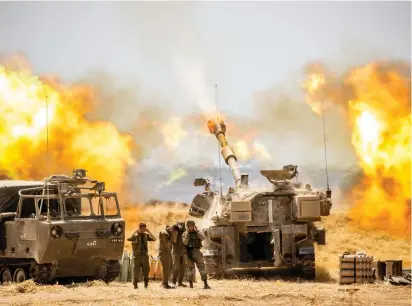  ?? (Yonatan Sindel/Flash90) ?? AN IDF ARTILLERY Corps gun shells a target in the Gaza Strip yesterday.