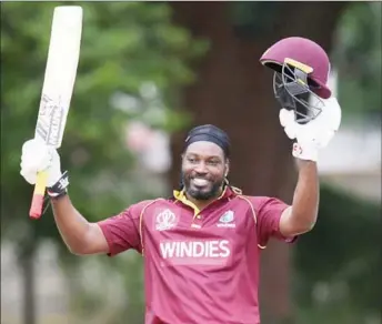  ?? (Photo courtesy Cricket West Indies) ?? The ‘Universe Boss’ Chris Gayle celebrates reaching three figures against minnows United Arab Emirates yesterday.