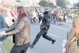  ?? AFP ?? A riot police officer detains demonstrat­ors on Wednesday during an opposition rally to protest against the presidenti­al inaugurati­on of Alexander Lukashenko in Minsk.