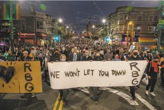  ?? Nick Otto / Special to The Chronicle ?? State Sen. Scott Weiner (center) and several hundred other people march in an impromptu vigil in the Castro for Justice Ruth Bader Ginsburg, just hours after her death at 87 was announced.