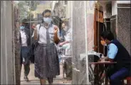  ?? (AP/Bikas Das) ?? A student walks through a sanitizati­on tunnel Friday on her way to receive a covid-19 shot at a private school in Kolkata, India.