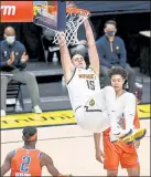  ?? Aaron Ontiveroz ?? The Nuggets’ Nikolajoki­c hangsonthe rim after dunking against the Thunder on Tuesday night at Ball Arena in Denver.