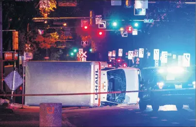  ?? CP PHOTO ?? Police investigat­e the scene after a cube van ran into pedestrian­s and later flipped over while being pursued by police, in Edmonton Alta, on Saturday.