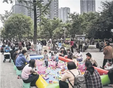  ??  ?? Children play in a park in front of residentia­l buildings at an affordable housing complex in Chongqing, China, on April 12, 2016. — Washington Post photo by Qilai Shen