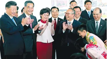  ?? — Reuters photo ?? Xi, Hong Kong Chief Executive Leung Chun-ying and Chief Executive-elect Carrie Lam clap after watching two Chinese opera performers during a visit to Hong Kong’s West Kowloon district.