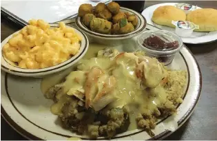  ?? PHOTO BY MATT MCCLANE ?? Thursday’s special at Southern Traditions restaurant is chicken and dressing with two sides, cranberry sauce and two rolls for $6.95. Fried okra and macaroni and cheese are shown above.