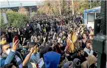  ?? PHOTO: AP ?? Students attend a protest inside Tehran University while anti-riot Iranian police prevent them from joining other protesters.