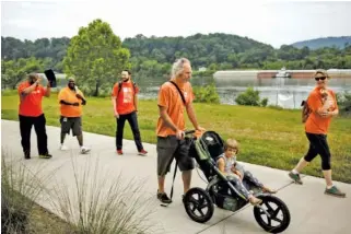  ??  ?? Above: People walk along the Tennessee Riverwalk for Gun Violence Awareness Day.