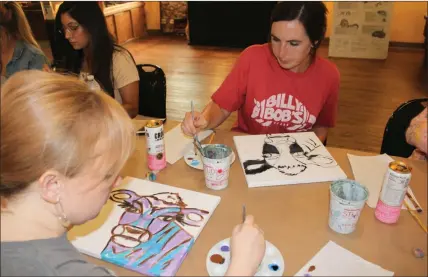  ?? Severo Avila ?? Rhea Aronalt and Emilia Jackson add color to their cows at the Rome Floyd ECO Center Thursday. Local artist Siri Selle led the Sip N’ Paint event which cost $40 and was a fundraiser for the ECO Center.