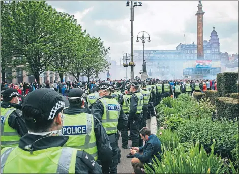  ?? Picture Andrew Cawley ?? Police on duty as Rangers fans are allowed to march to George Square, Glasgow, in May