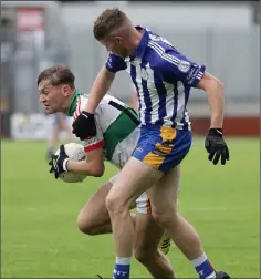  ??  ?? Luke Sinnott of Taghmon-Camross tries to escape the close attention of Gusserane’s Mark O’Neill.