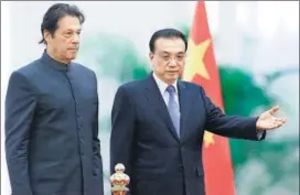  ?? AFP ?? Pakistani Prime Minister Imran Khan (left) and China's Premier Li Keqiang attend a welcome ceremony at the Great Hall of the People in Beijing on Saturday.