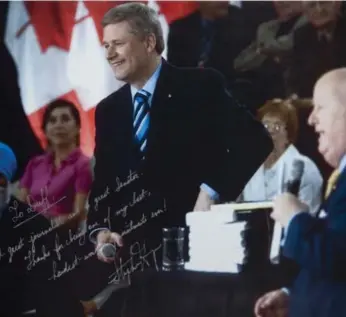  ?? JUSTIN TANG/THE CANADIAN PRESS ?? In a photo taken at a 2009 town hall event and signed by Prime Minister Stephen Harper, Mike Duffy is hailed for his work. The signed photo was entered into evidence on Day 3 of the suspended senator’s trial in Ottawa.