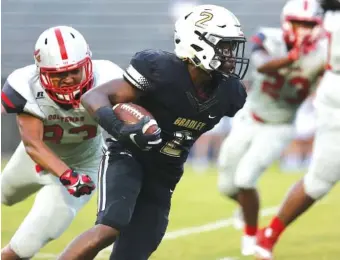  ?? STAFF PHOTOS BY ERIN O. SMITH ?? Ooltewah’s Josiah High chases after Bradley Central’s Ricky McCleary as he runs the ball downfield during Friday’s game at Bradley Central High School.