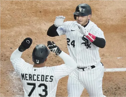  ?? NUCCIO DINUZZO/GETTY IMAGES ?? Yermin Mercedes congratula­tes Yasmani Grandal after his three-run homer in the second inning Tuesday tied the game against the Twins.