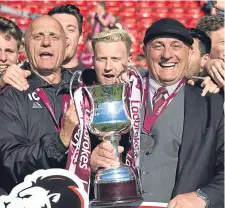  ??  ?? Arbroath boss Dick Campbell (right) celebrates lifting the League Two title with his twin brother Ian.