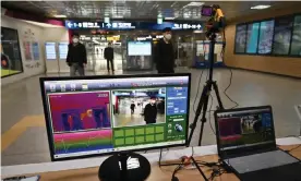  ??  ?? A thermal camera set up to monitor the body heat of passengers at a train station in Daegu. Photograph: Jung Yeon-Je/AFP via Getty Images