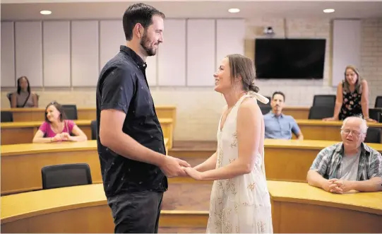  ?? HYOUNG CHANG The Denver Post/TNS ?? Trevor Bazley, left, and Lexxa Kever take part in a rehearsal for their wedding in the University of Denver’s Daniels College of Business, room 300, in Denver on Sept. 1. The couple decided to get married in the classroom where they first met.