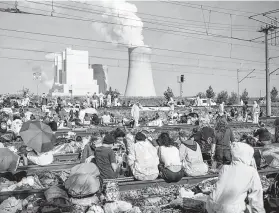  ?? Marcel Kusch / Associated Press ?? Numerous environmen­tal activists block the tracks of the coal transport railway Saturday in Rommerskir­chen, Germany.