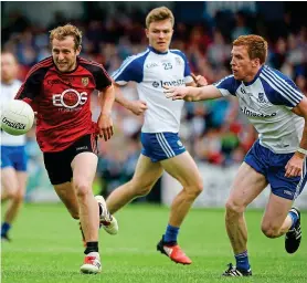  ??  ?? Forceful: Darren O’Hagan shakes off Fintan Kelly of Monaghan