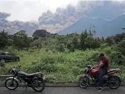  ?? [AP PHOTO] ?? Volcan de Fuego, or Volcano of Fire, blows outs a thick cloud of ash Sunday as seen from Alotenango, Guatemala.