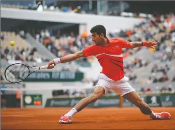  ?? The Associated Press ?? AIMING FOR NO. 2: Serbia’s Novak Djokovic plays a shot against Austria’s Dominic Thiem during their June 7, 2019, semifinal match of the French Open at the Roland Garros stadium in Paris. Djokovic is bidding for a second title there and 18th Grand Slam trophy overall, which would move him within two of Roger Federer’s record for men and one behind second-place Nadal.