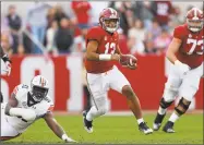  ?? Kevin C. Cox / Getty Images ?? Alabama’s Tua Tagovailoa rushes away from Auburn’s Nick Coe during Saturday’s contest.