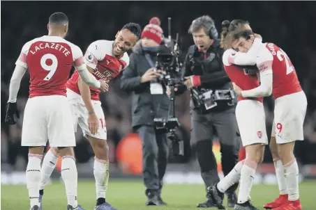  ??  ?? Arsenal’s Pierre-Emerick Aubameyang (second from left) and Alexandre Lacazette celebrate beating Tottenham.