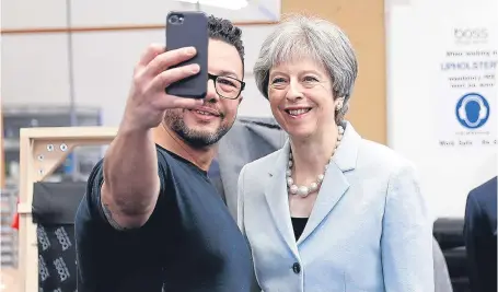  ?? Picture: Getty. ?? Prime Minister Theresa May poses for a selfie with upholstere­r Derek Whitehouse in Dudley.