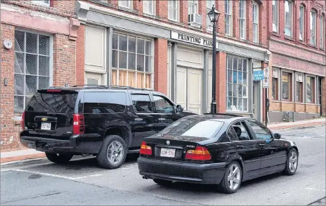  ?? CP PHOTO ?? The building where businessma­n Richard Oland was found dead is seen in Saint John, N.B., on Monday, July 14, 2014. The battered body of multi-millionair­e Richard Oland attracted unwanted attention from several Saint John police officers who visited the scene just to get a look, the Dennis Oland murder trial was told Friday.