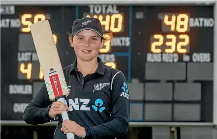  ?? PHOTOSPORT ?? Amelia Kerr stands in front of the scoreboard after setting a world record knock of 232 not out.