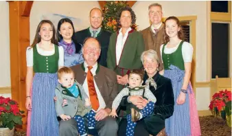  ??  ?? Johannes von Trapp and his wife Lynne with their children and grandchild­ren. Son Sam and daughter Kristina (pictured in the middle of the back row) now run the family lodge