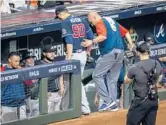  ?? ANNIE MULLIGAN/THE NEW YORK TIMES ?? Starter Charlie Morton, right, is helped off the field during the Braves’ win in the World Series opener Tuesday. Morton broke his right leg.