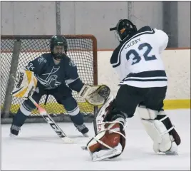  ?? STAFF PHOTO BY MICHAEL REID ?? In a rarely seen shootout matchup, La Plata goaltender Garrett Cherry moves in on player Chris Palombi, who stymied Cherry on the attempt.