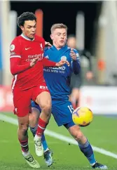  ??  ?? Liverpool’s Trent Alexander-arnold, left, and Leicester City’s Harvey Barnes