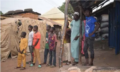  ?? ?? People gather around an area were gunmen kidnapped school children in Chikun, Nigeria. Photograph: AP Photo/AP