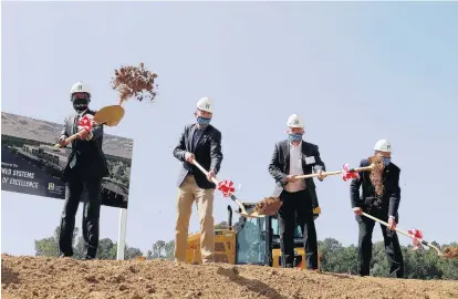  ?? KAITLIN MCKEOWN/STAFF ?? Officials break ground at the future site of Huntington Ingalls Industries Unmanned Systems Center of Excellence on Tuesday in Hampton.