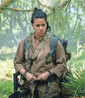  ??  ?? Gina Rodriguez is Anya, a gritty paramedic who investigat­es the forbidden, otherworld­ly Shimmer zone in “Annihilati­on.” PHOTOS BY PETER MOUNTAIN