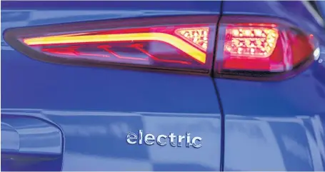  ??  ?? A rear tail light is illuminate­d on a Kona electric compact SUV.