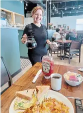  ?? KEVIN WERNER METROLAND ?? Anna Kaleci offers service with a smile at Sammy's new location at 1080 Wilson St. W.