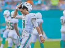  ?? JIM RASSOL/SUN SENTINEL ?? Dolphins quarterbac­k Brock Osweiler (8) walks off the field after throwing an intercepti­on late in the second half against the Bears.