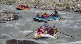  ?? — PTI ?? Tourists participat­e in river rafting in the Beas river as authoritie­s ease lockdownre­strictions during Unlock 4 in Kullu district on Monday.