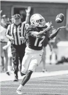  ?? STAFF PHOTO BY DOUG STRICKLAND ?? UTC wide receiver Xavier Borishade catches a pass before running it in for a touchdown during the Mocs’ football game against Presbyteri­an at Finley Stadium earlier this month. He has scored five TDs.