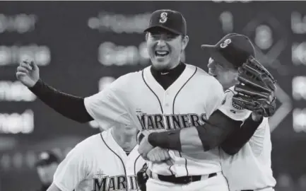  ??  ?? Mariners starting pitcher Hisashi Iwakuma is hugged by first baseman Logan Morrison after the final out of Iwakuma's nohitter against the Baltimore Orioles on Wednesday at Safeco Field in Seattle. Ted S. Warren, The Associated Press