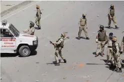  ??  ?? KASHMIR: An Indian policeman throws stones on Kashmiri students as they clash in Srinagar, Indian controlled Kashmir yesterday. —AP